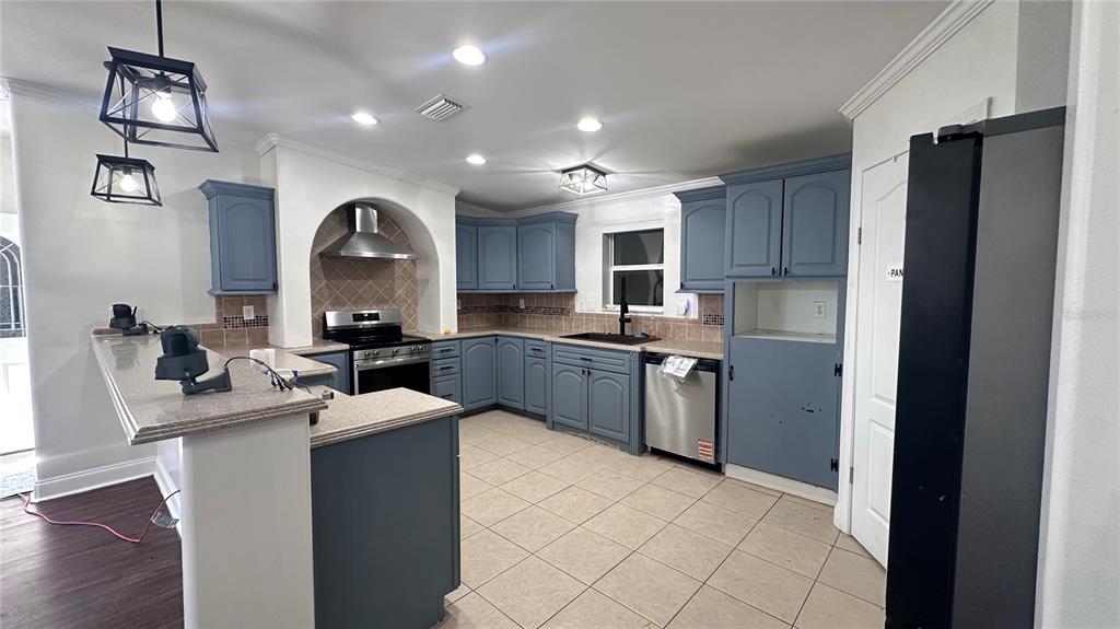 35495 Singletary Road Myakka City, FL 34251 - Photo 28 of 74 a kitchen with a sink a counter top space and stainless steel appliances