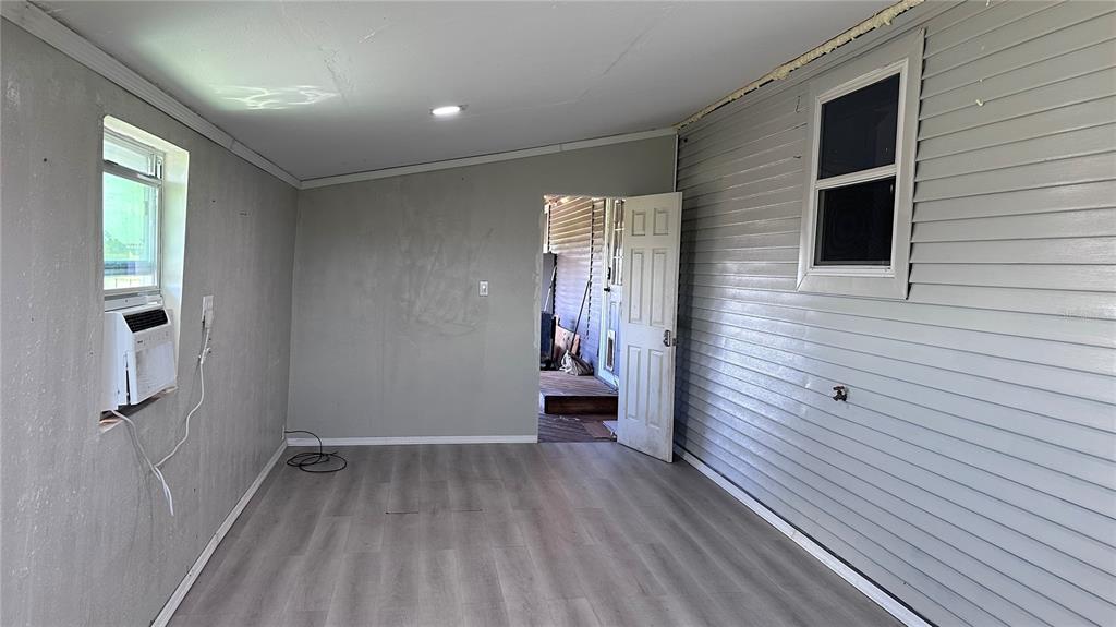 35495 Singletary Road Myakka City, FL 34251 - Photo 33 of 74 a view of a hallway with wooden floor and staircase