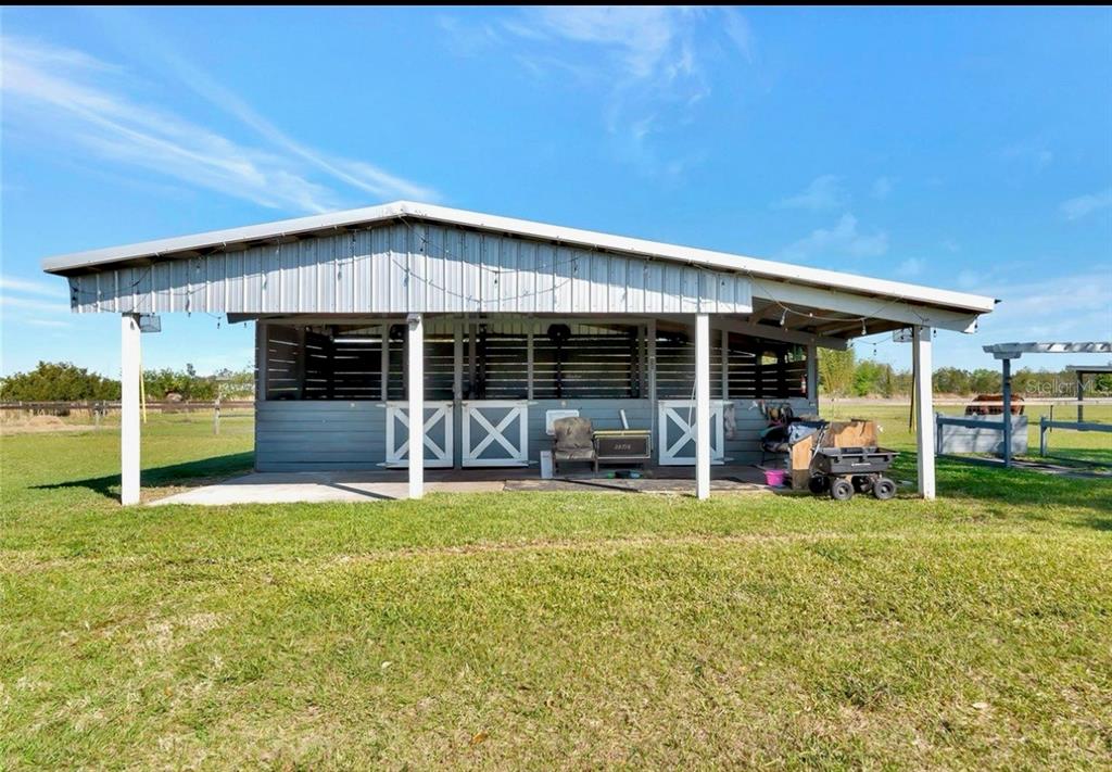 35495 Singletary Road Myakka City, FL 34251 - Photo 51 of 74 a view of a house with a backyard porch and sitting area