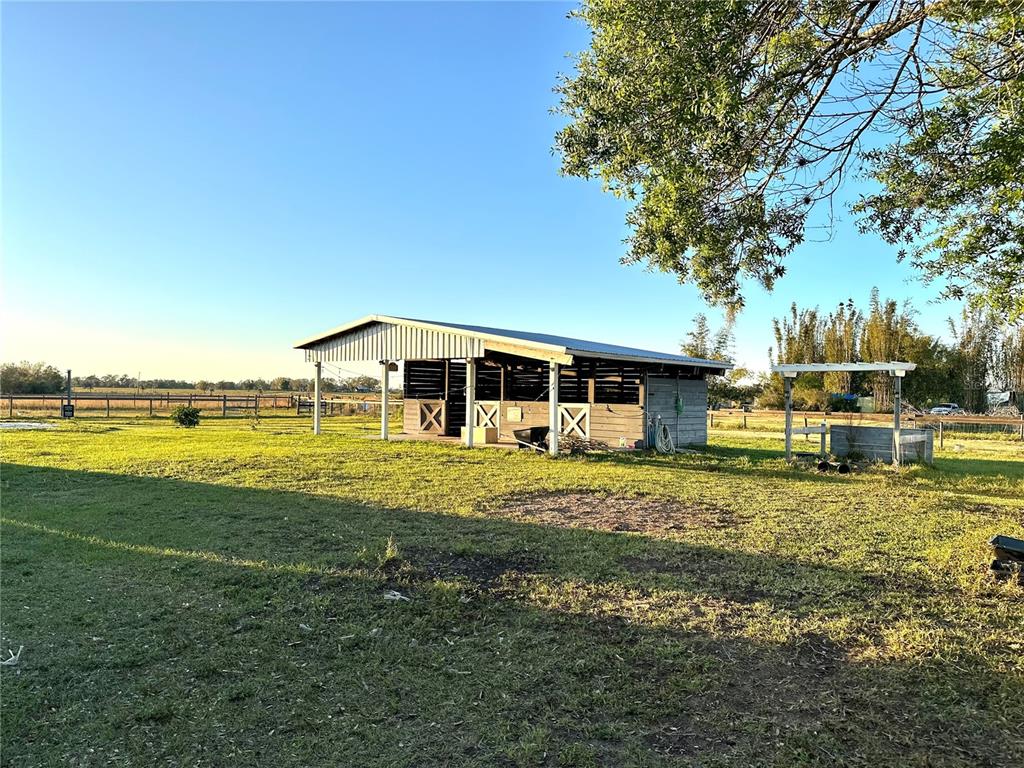 35495 Singletary Road Myakka City, FL 34251 - Photo 52 of 74 a backyard of a house with table and chairs