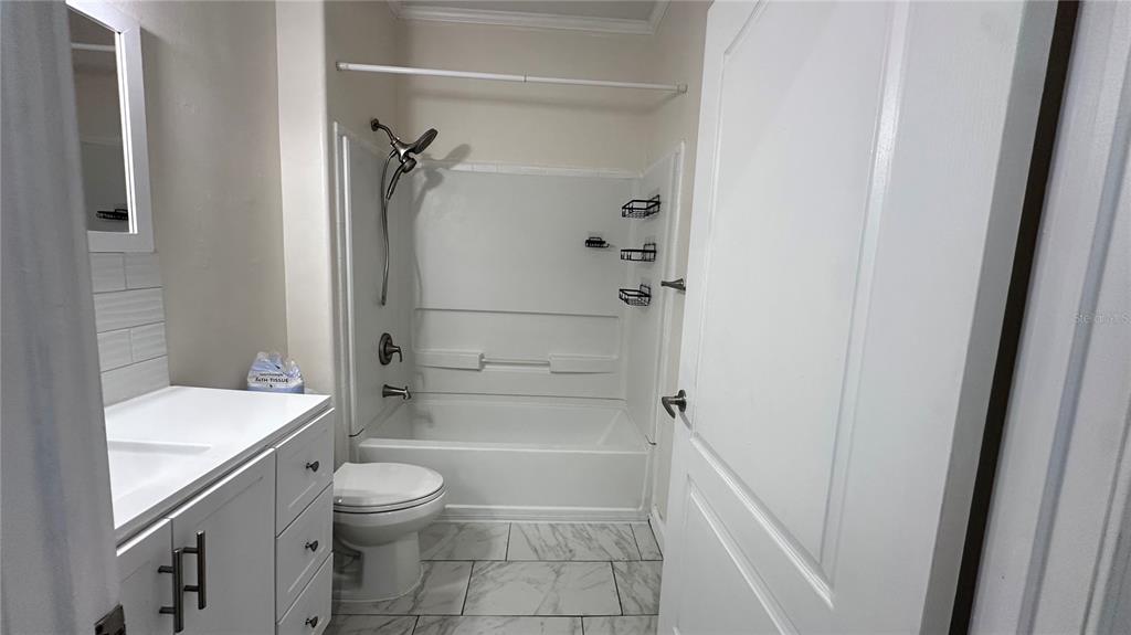 35495 Singletary Road Myakka City, FL 34251 - Photo 68 of 74 a bathroom with a granite countertop sink toilet and shower