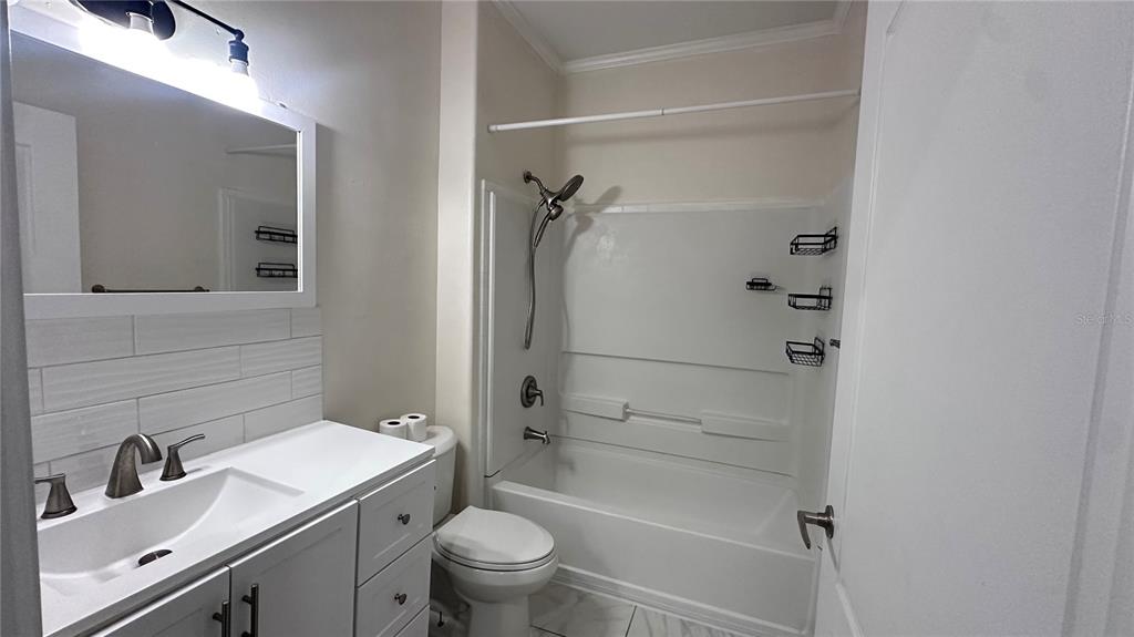 35495 Singletary Road Myakka City, FL 34251 - Photo 69 of 74 a bathroom with a granite countertop sink toilet and shower