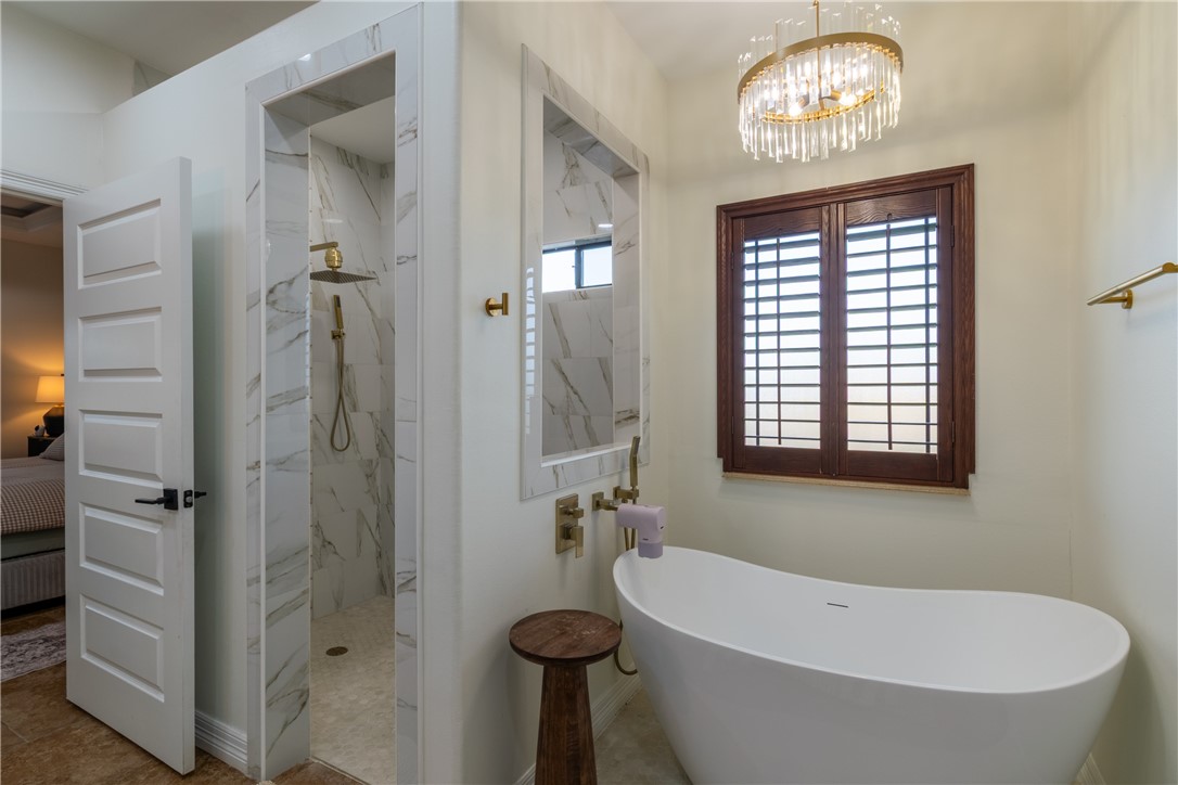 108 County Road 1601 Alice, TX 78332 - Photo 21 of 32 a bathroom with a tub a sink and a window