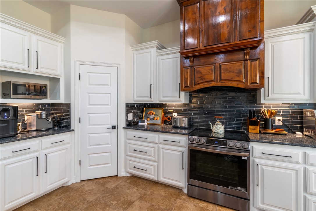 108 County Road 1601 Alice, TX 78332 - Photo 7 of 32 a kitchen with stainless steel appliances granite countertop a stove and cabinets
