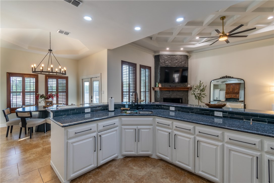 108 County Road 1601 Alice, TX 78332 - Photo 8 of 32 a open kitchen with granite countertop a sink and white cabinets
