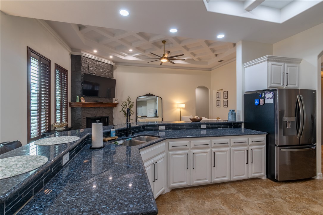 108 County Road 1601 Alice, TX 78332 - Photo 9 of 32 a kitchen with stainless steel appliances granite countertop a refrigerator a stove a sink and a microwave