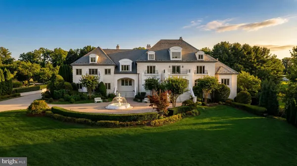 a front view of a house with a garden and porch
