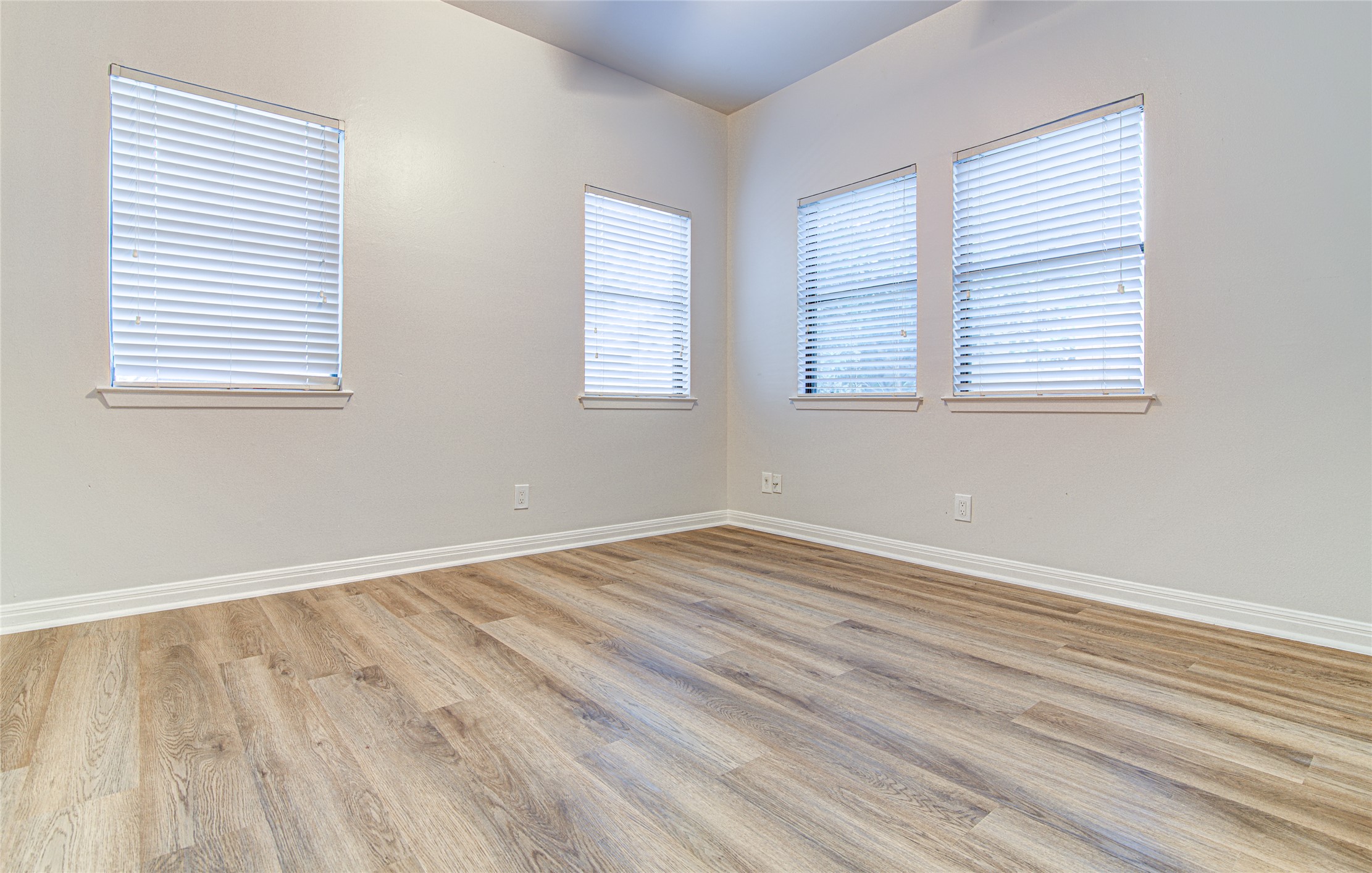 311 West Mary Street Austin, TX 78704 - Photo 17 of 35 Natural light bathes this bedroom with durable hardwood-style flooring, ready for your personalized touch.