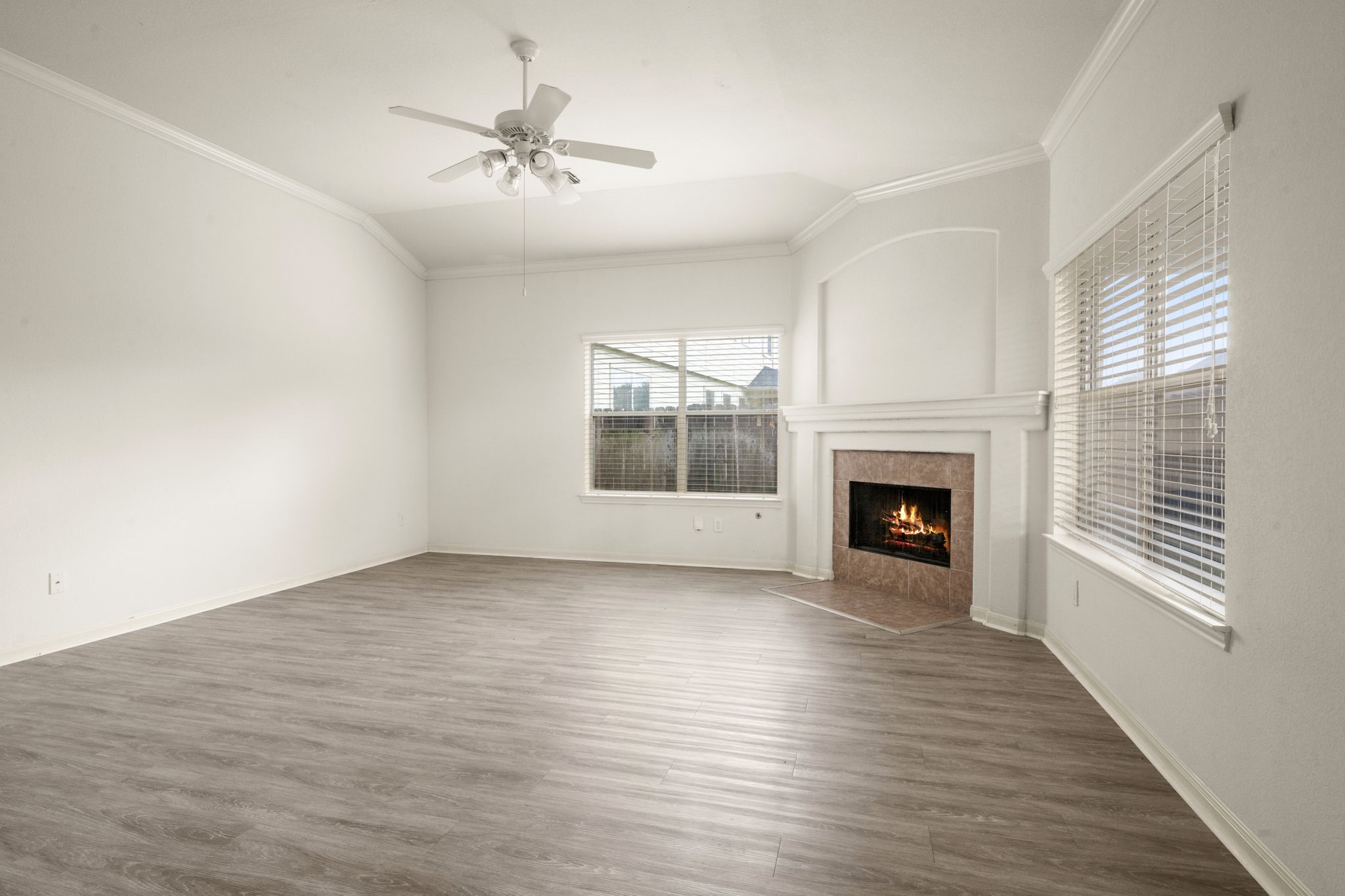 7803 Blue Lake Drive Rosenberg, TX 77469 - Photo 24 of 31 wooden floor fireplace and windows in an empty room