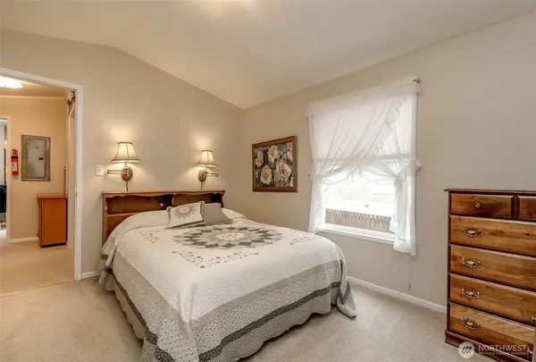 a bed room with a bed and a window
