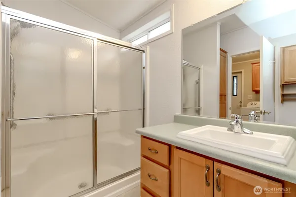 a bathroom with a double vanity sink and mirror