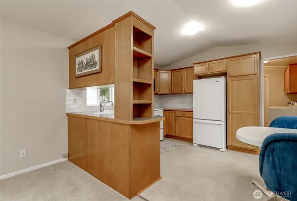 a kitchen with stainless steel appliances a refrigerator and a cabinets