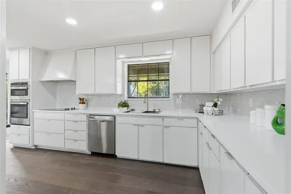 a kitchen with sink cabinets and window