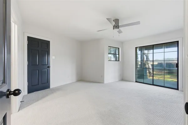 an empty room with windows and closet