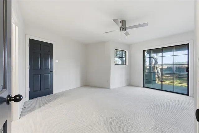 an empty room with windows and closet