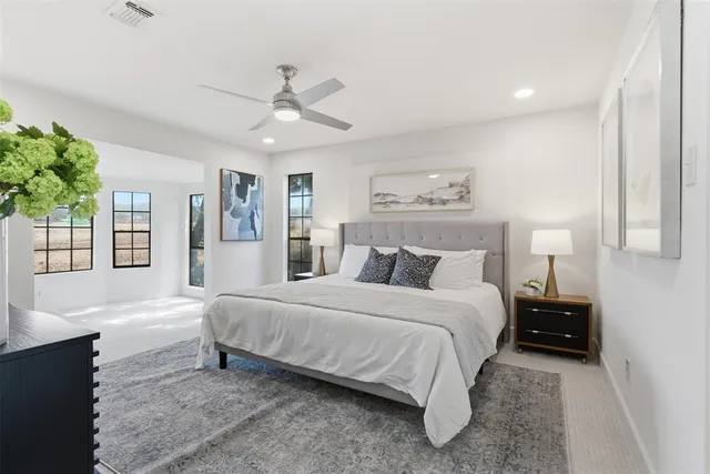 a bedroom with a large bed and a chandelier