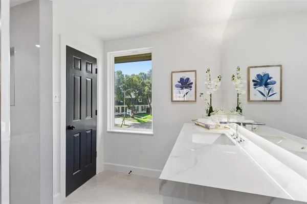 a spacious bedroom with a bed and a window