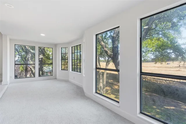 a view of an empty room with windows