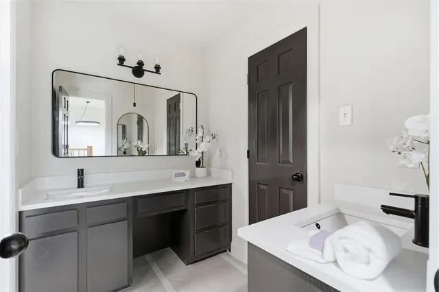 a bathroom with a double vanity sink mirror and