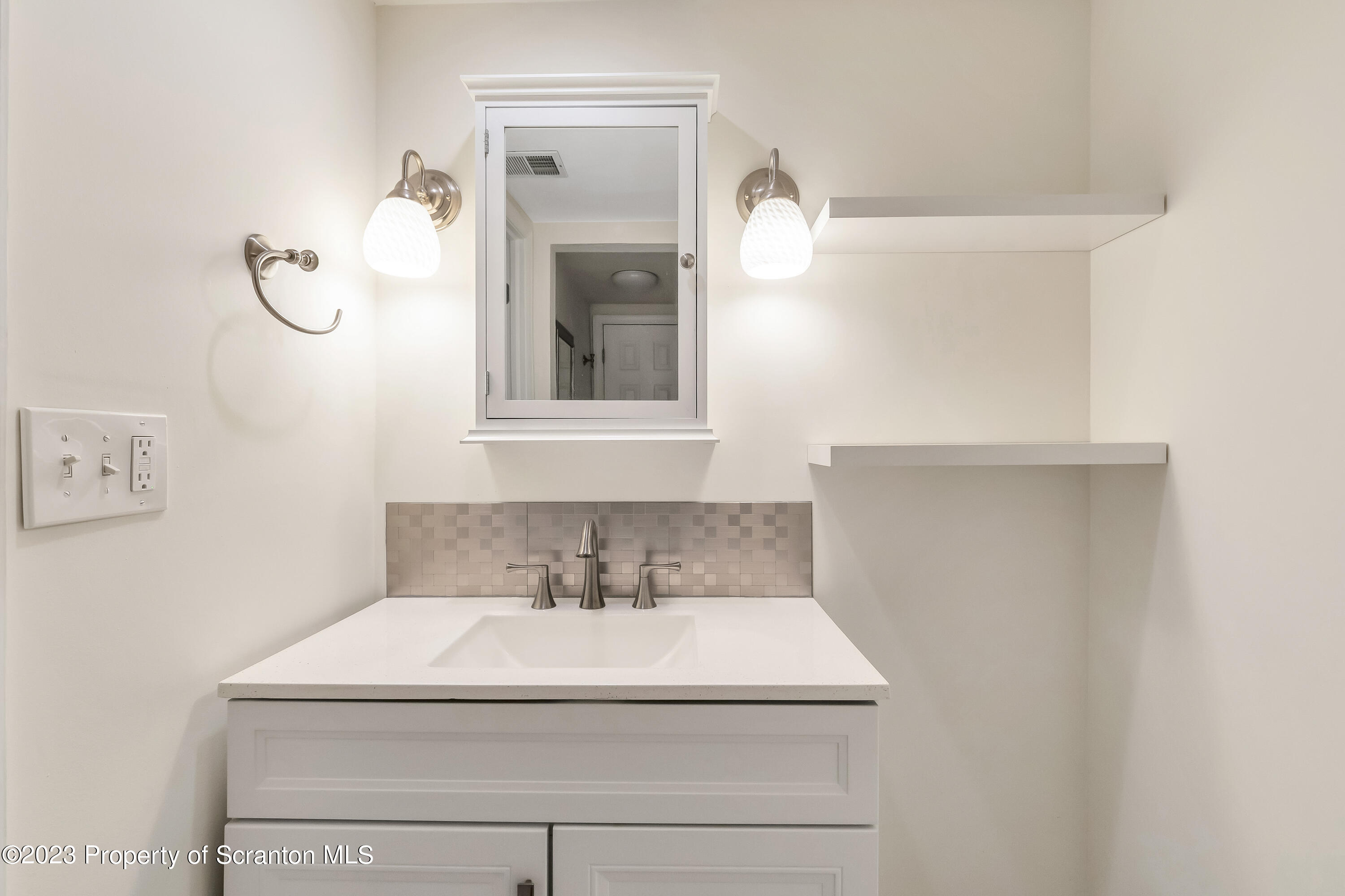 1203 Summit Pointe Scranton, PA 18508 - Photo 12 of 32 a bathroom with a sink and mirror