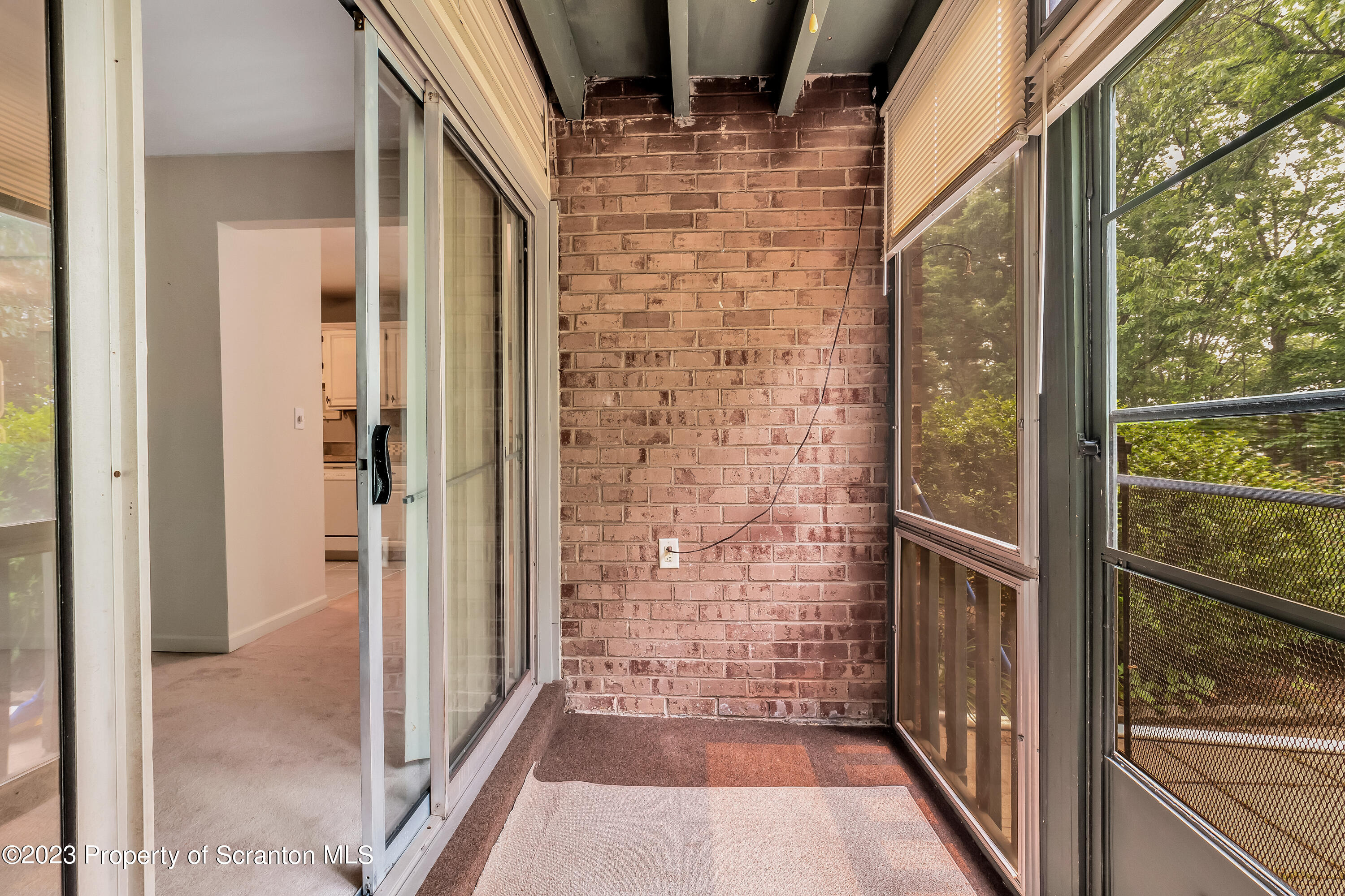1203 Summit Pointe Scranton, PA 18508 - Photo 19 of 32 a view of a brick house with wooden floor and windows