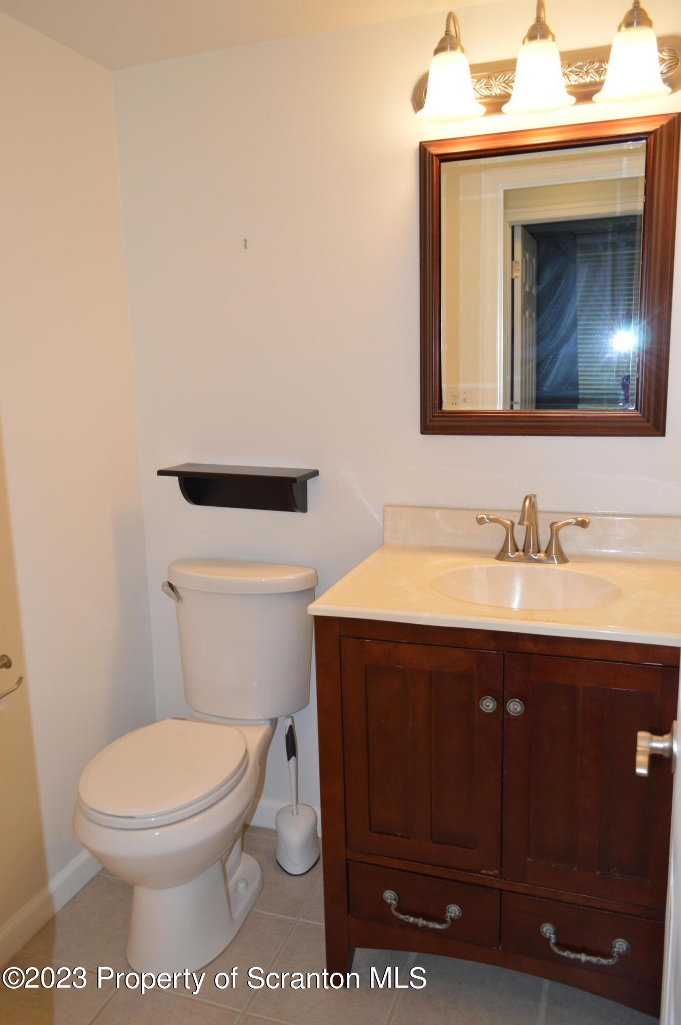 1203 Summit Pointe Scranton, PA 18508 - Photo 20 of 32 a bathroom with a toilet a sink and mirror