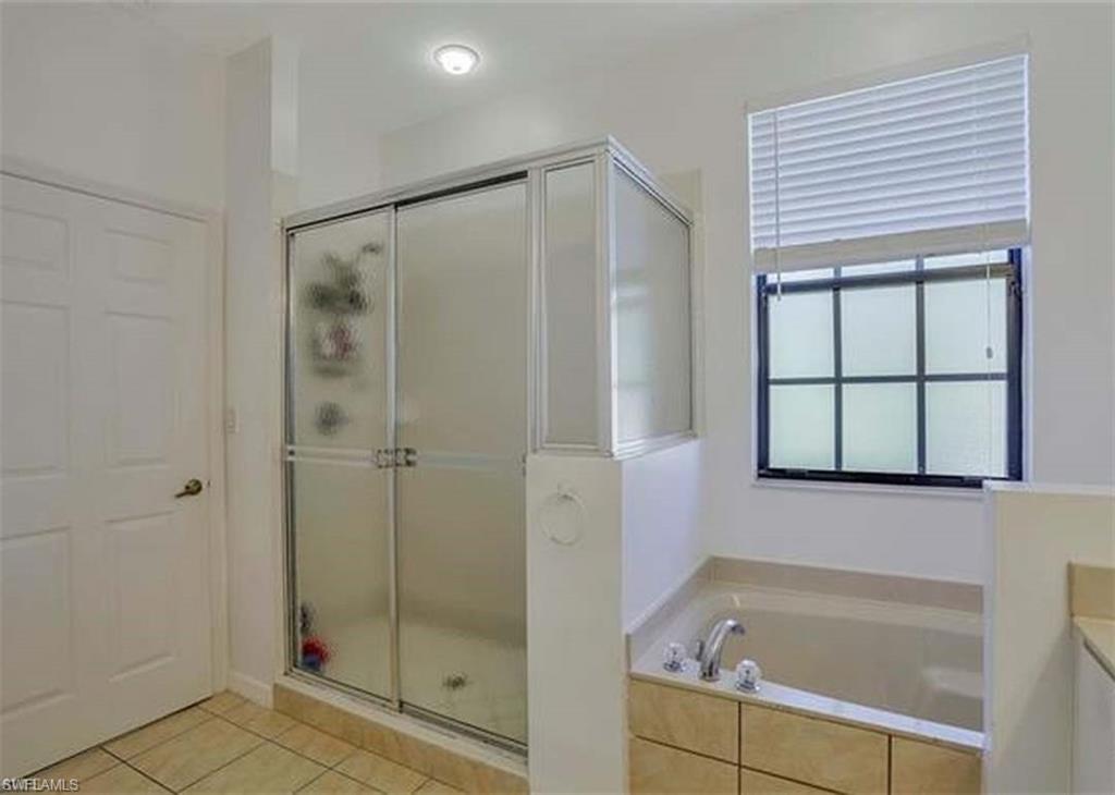 14751 Pinnacle Place Naples, FL 34119 - Photo 7 of 9 a bathroom with a shower and a bathtub