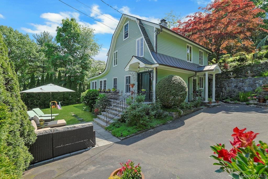 97 Underhill Road Scarsdale, NY 10583 - Photo 33 of 39 a front view of a house with garden