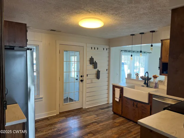 a room with two washing machine and wooden floor