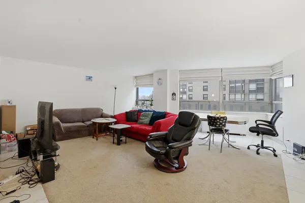 a living room with furniture gym equipment and a floor to ceiling window