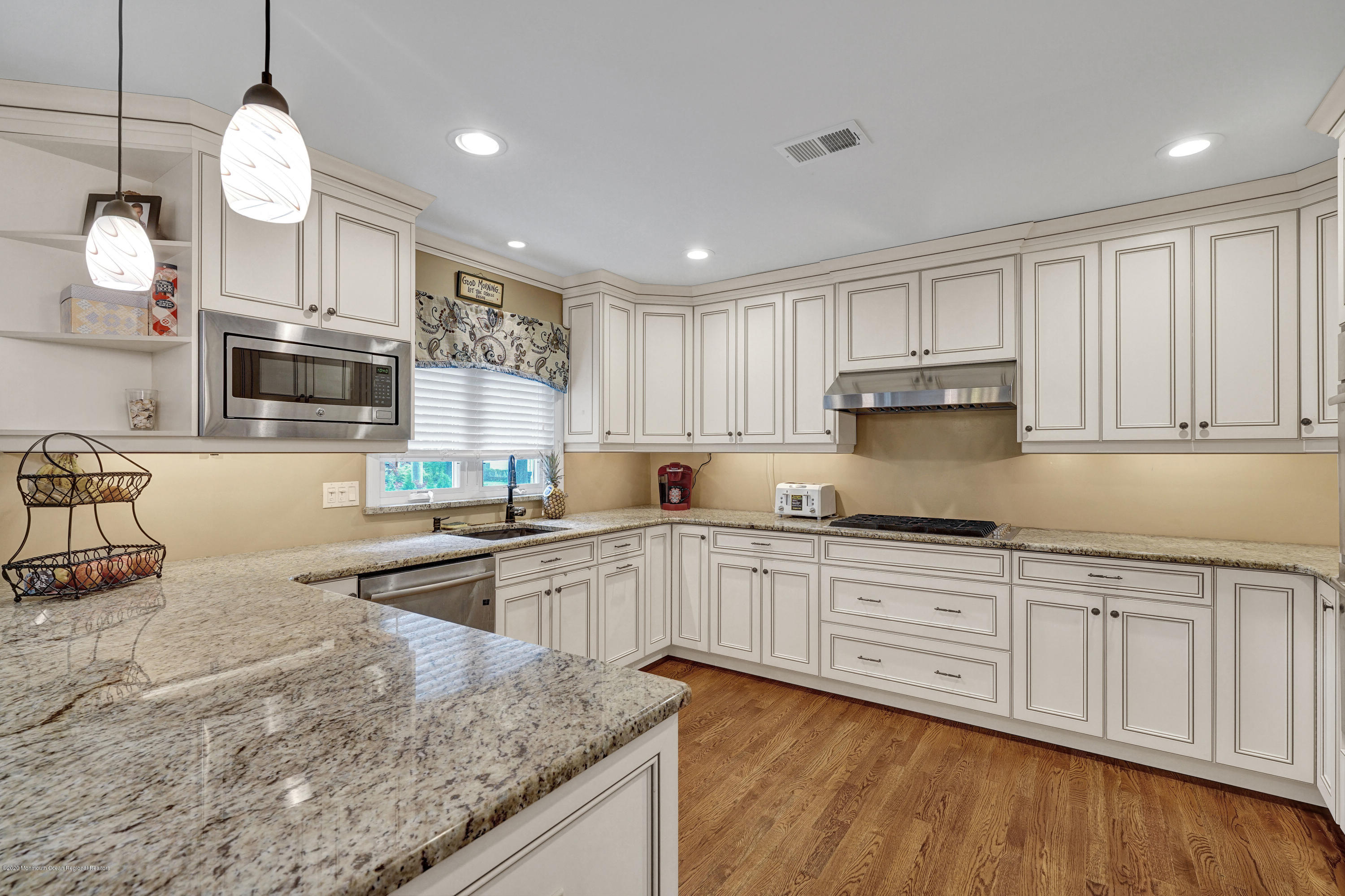 712 Midstreams Road Brick, NJ 08724 - Photo 9 of 33 a kitchen with granite countertop white cabinets and stainless steel appliances