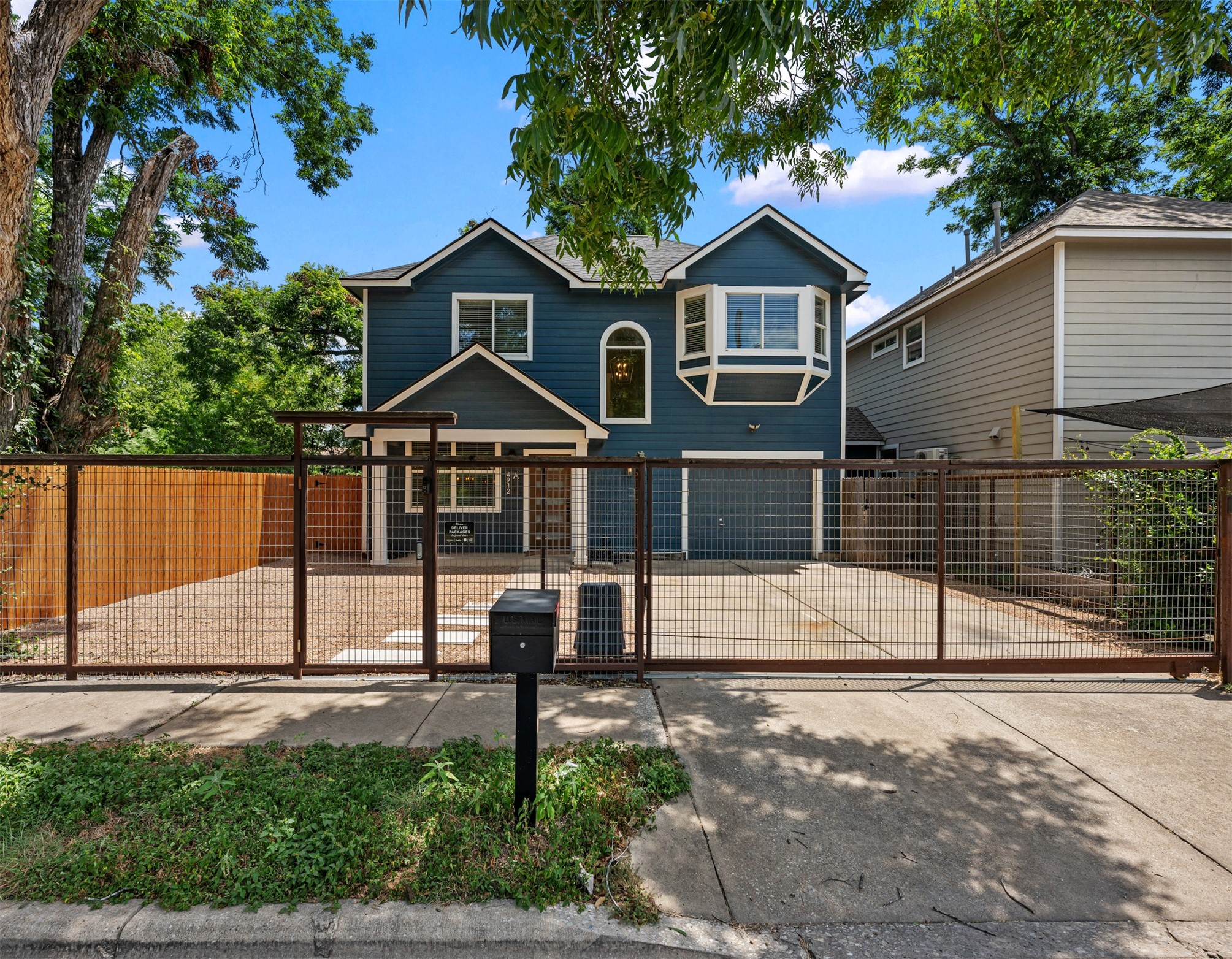 4912 Sara Drive, Unit A Austin, TX 78721 - Photo 1 of 28 Front exterior with automatic driveway gate, garage and fully fenced front yard.
