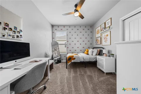 a bedroom with furniture and a flat screen tv