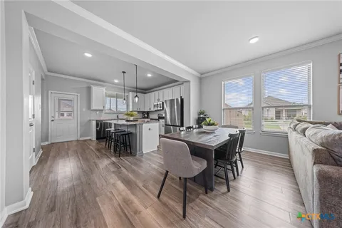 a view of a dining room with furniture and wooden floor