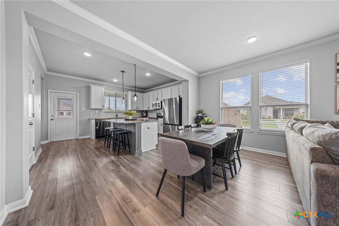 7513 Hudson Grove Drive Temple, TX 76502 - Photo 17 of 38 a view of a dining room with furniture and wooden floor