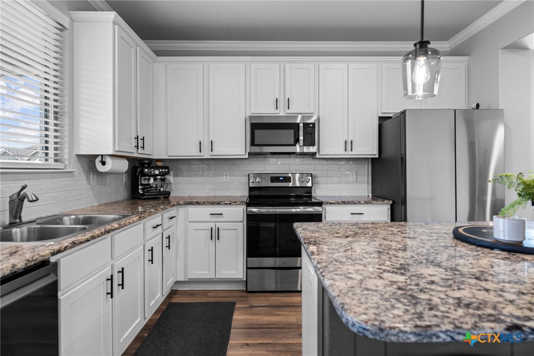 7513 Hudson Grove Drive Temple, TX 76502 - Photo 20 of 38 a kitchen with stainless steel appliances granite countertop a sink stove and refrigerator