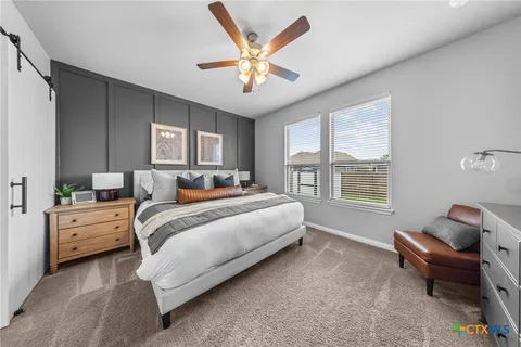 a bed room with bed and window