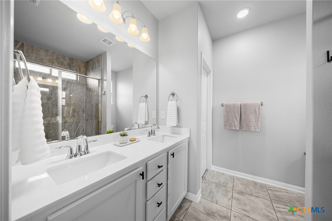 7513 Hudson Grove Drive Temple, TX 76502 - Photo 31 of 38 a bathroom with a sink double vanity and a mirror