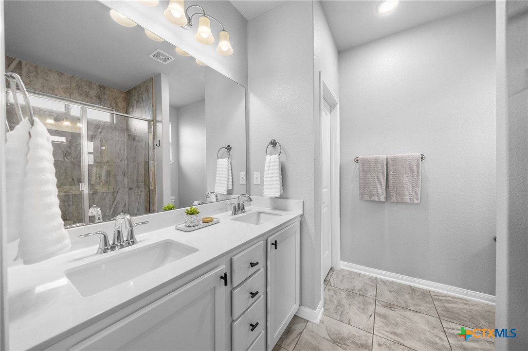 7513 Hudson Grove Drive Temple, TX 76502 - Photo 32 of 38 a bathroom with a double vanity sink mirror and double