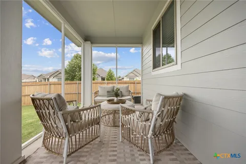a view of a chair and table in the balcony