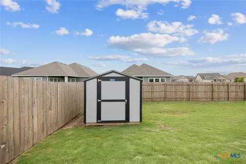 a view of a house with a yard and sitting area