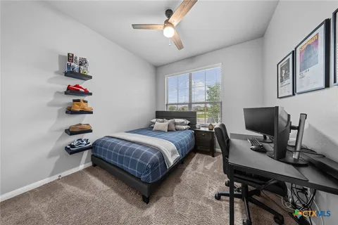 a bedroom with bed and a large window