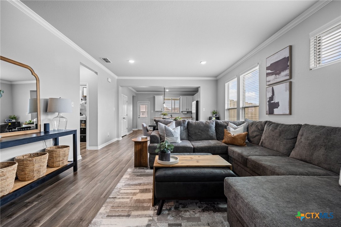 7513 Hudson Grove Drive Temple, TX 76502 - Photo 9 of 38 a living room with furniture wooden floor and a window