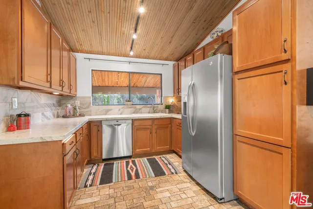 an outdoor sitting area with furniture and wooden floor