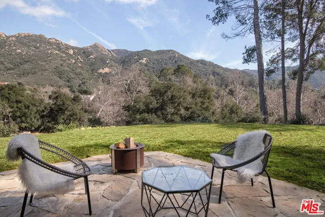 a bathroom with a sink and mirror with toilet