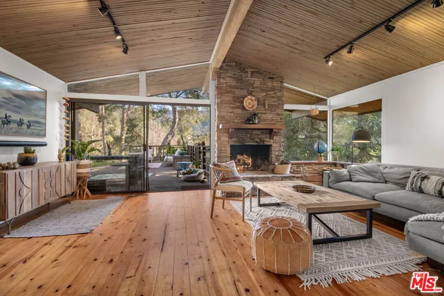 a bedroom with furniture and a large window