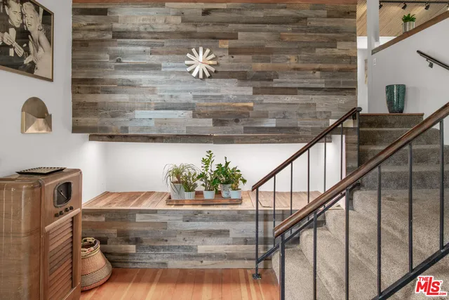 a living room with furniture a rug and a window