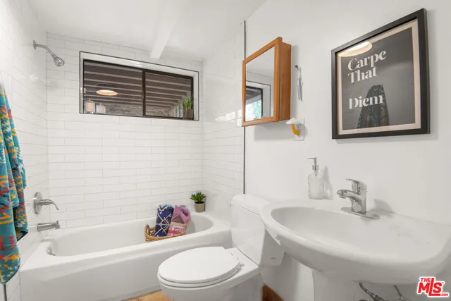 a view of a patio with table and chairs and potted plants
