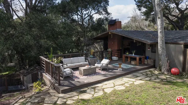 a view of a yard with patio and a garden