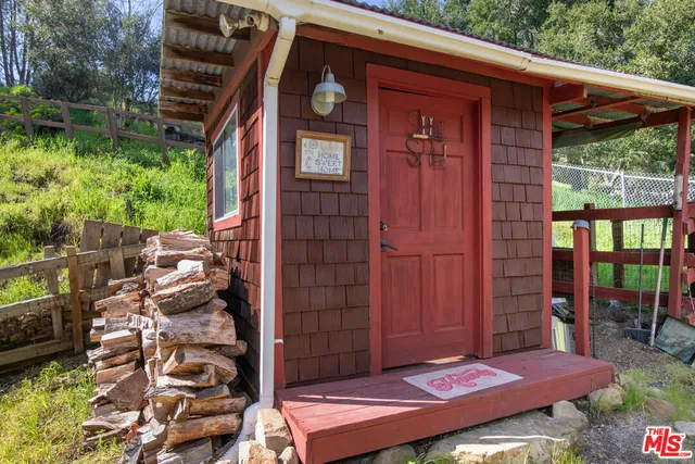 a view of a house with a patio and a yard